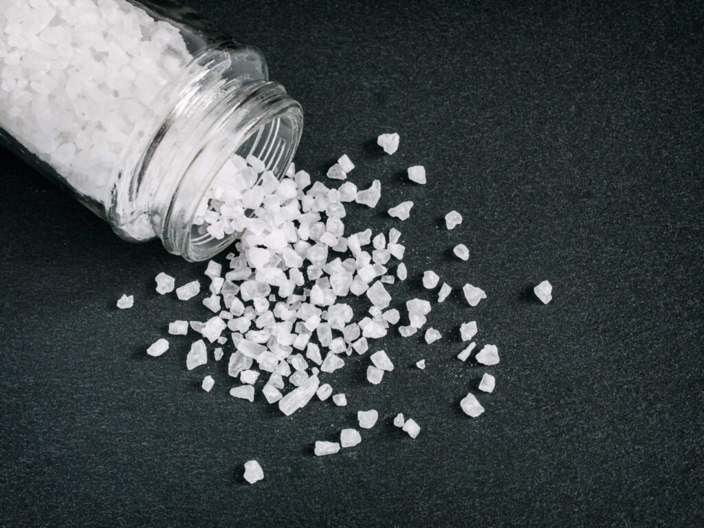 coarse sea salt on stone close up. Flat lay or top view